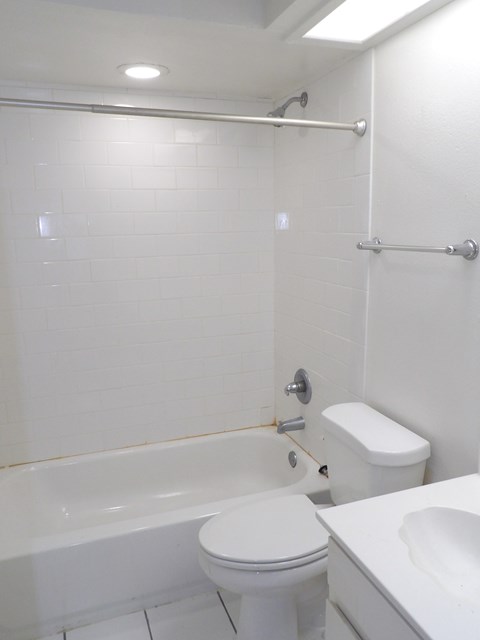 A white toilet and sink in a bathroom.