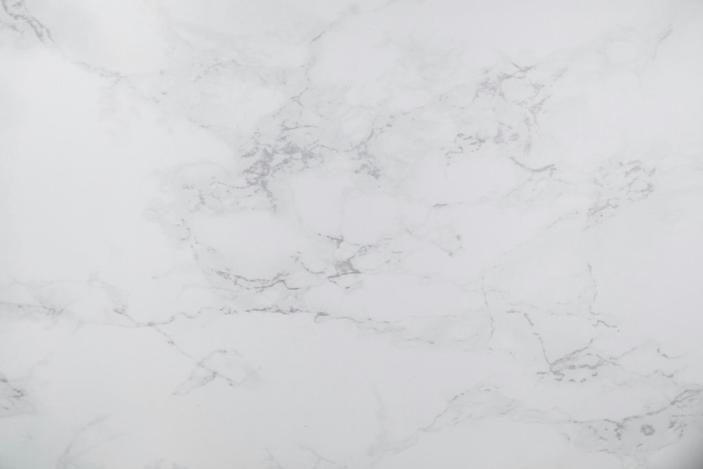A close up of a white marble surface with natural veining.