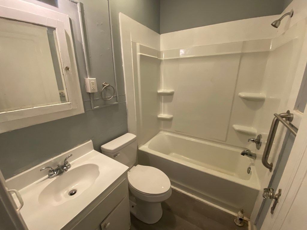 A white sink and toilet in a bathroom.