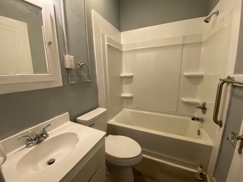 A white sink and toilet in a bathroom.