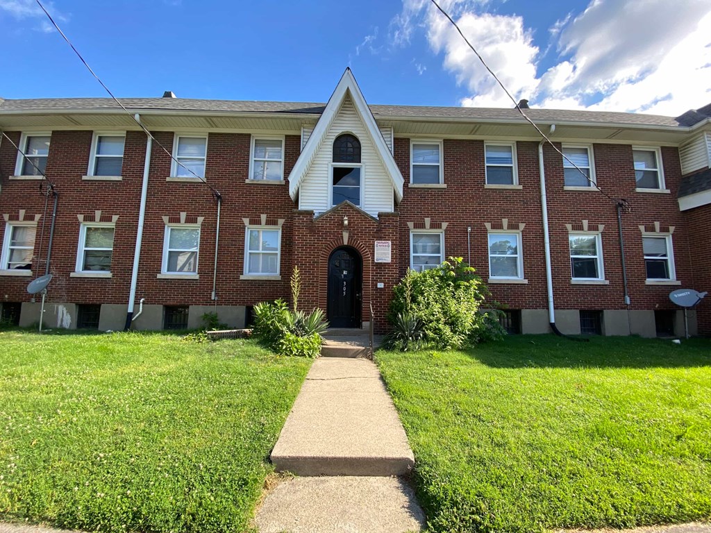 A brick building with a black door and windows.