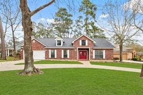 A red brick house with a grey roof and a red door.