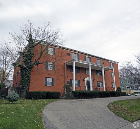 A red brick building with white trim and a covered walkway.