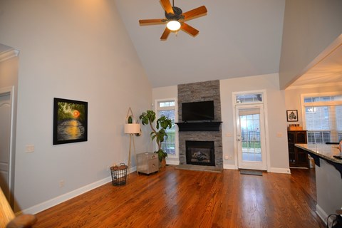 A living room with a fireplace and a painting on the wall.