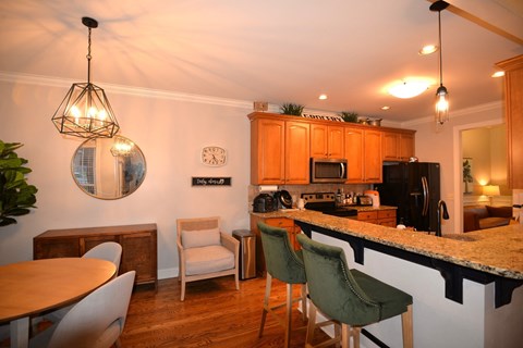 A kitchen with a table and chairs.