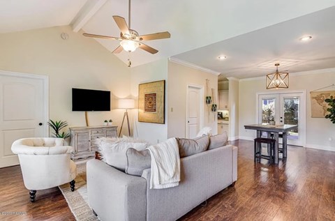 A living room with a grey couch and a white chair.
