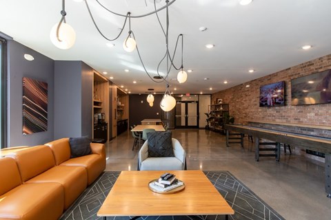 A modern living room with a wooden coffee table and a large orange sofa.