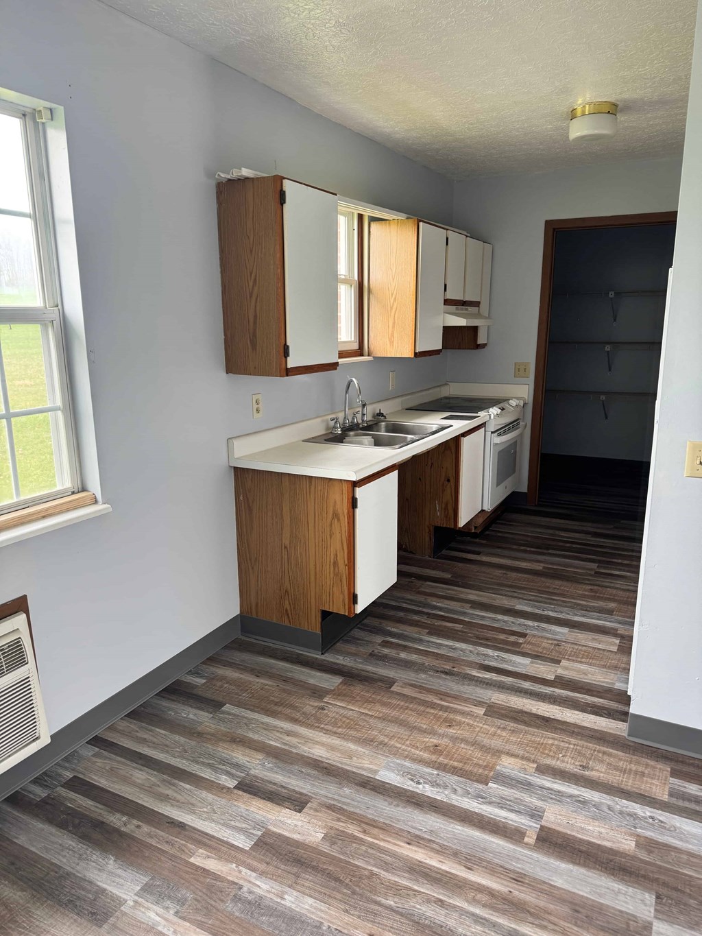A kitchen with wooden cabinets and a sink.