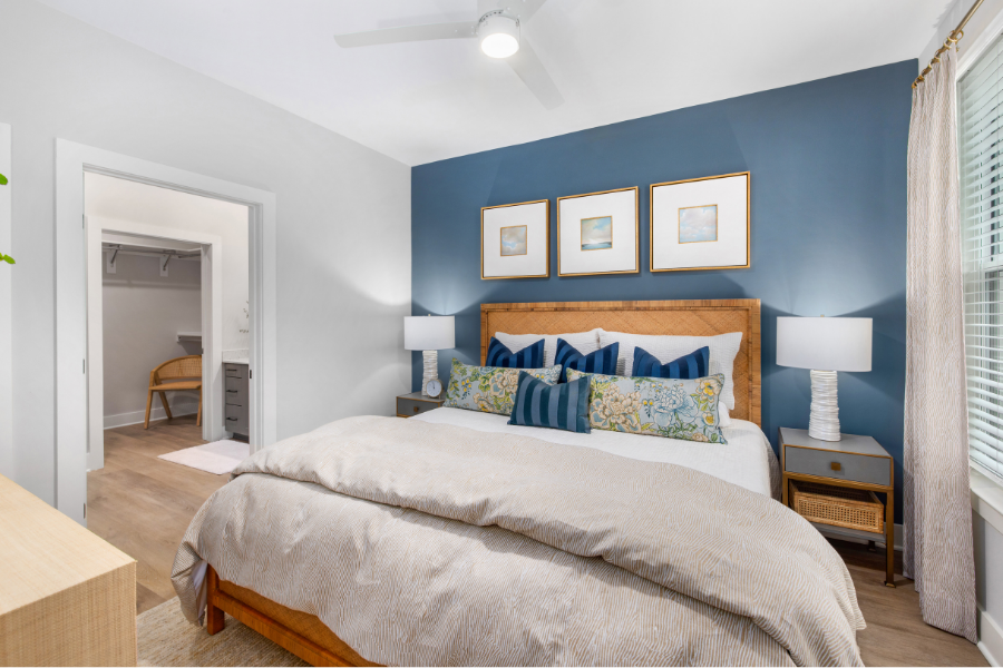 A bedroom with a large bed and a ceiling fan.