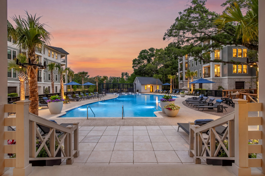 A beautiful outdoor swimming pool area with lounge chairs and umbrellas.