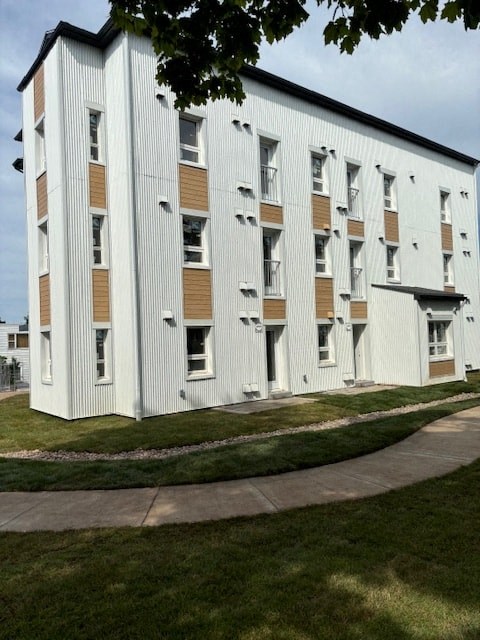 A white building with brown trim and windows.