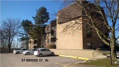 A building with the address 57 Bridge St. W. is shown with cars parked in front.