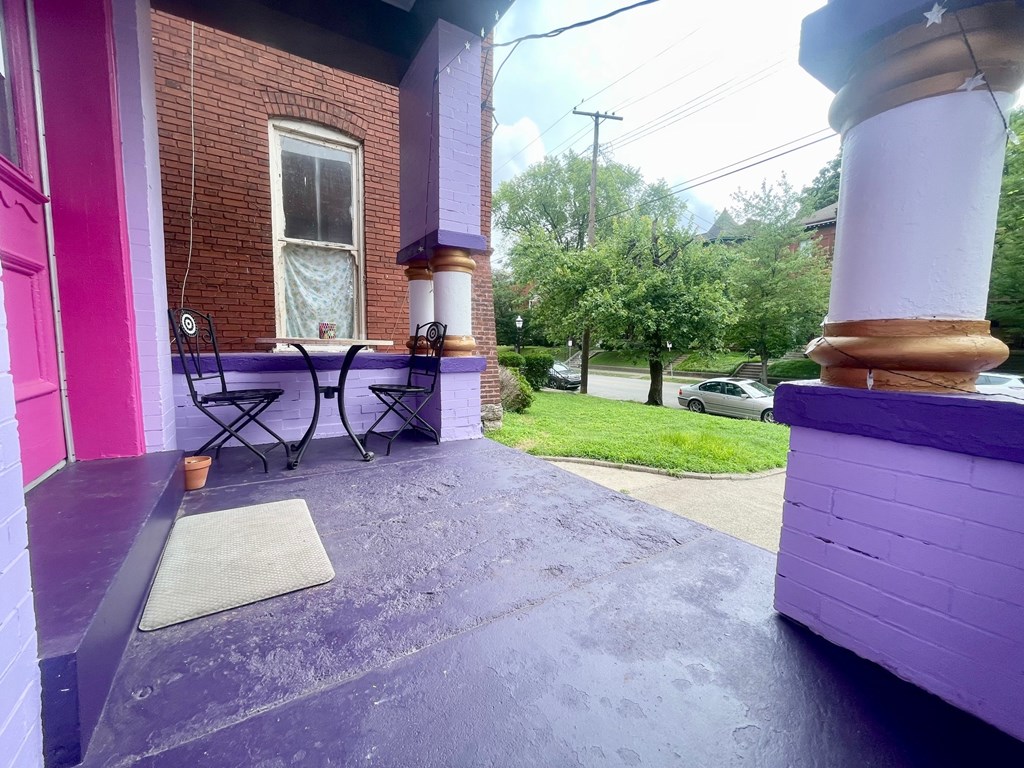 A purple house with a patio and a table.