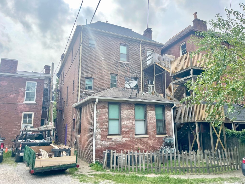 A red brick house with a truck parked in front.