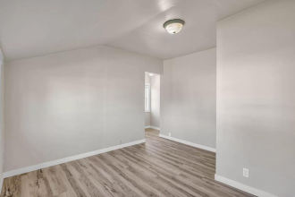 A room with wooden floors and white walls.