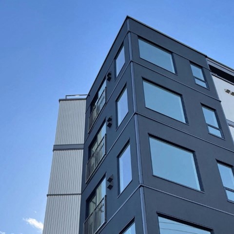A tall building with a blue sky in the background.