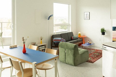 A dining table with a blue top and four chairs around it.