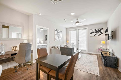 A dining room with a table and chairs.