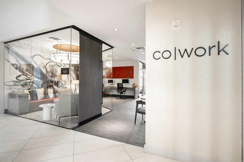 A modern office space with a glass wall and a white interior.