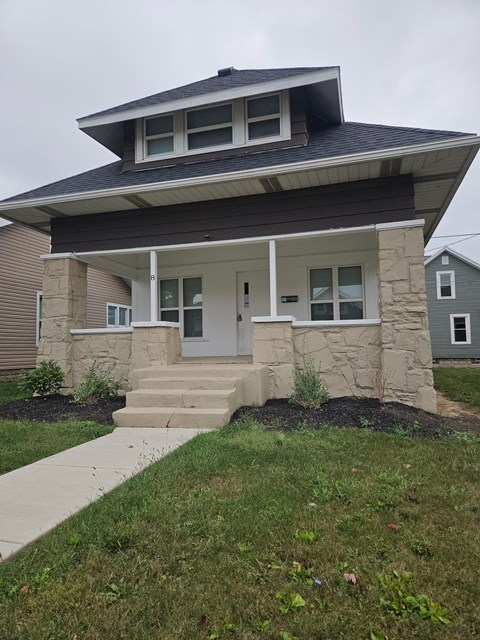A house with a grey front door and a grey wall.