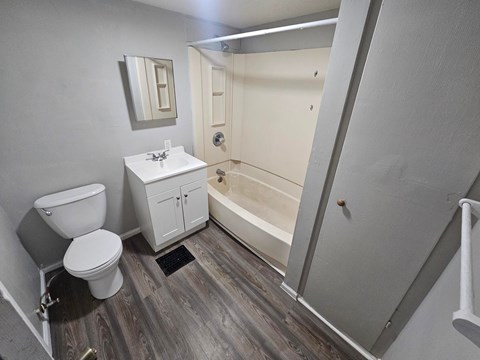 A bathroom with a toilet, sink, and bathtub.
