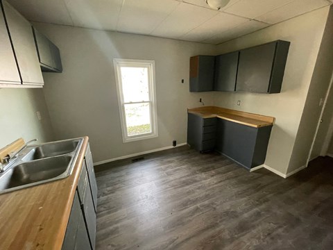 A kitchen with a sink and a window.