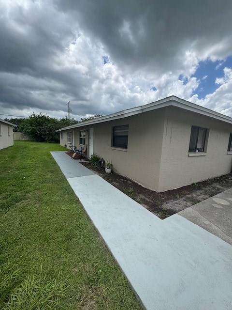 A house with a concrete walkway leading to the front door.