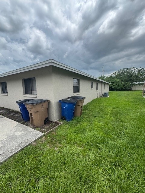 A house with two trash bins in front of it.