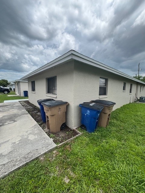 A house with two trash bins in front of it.