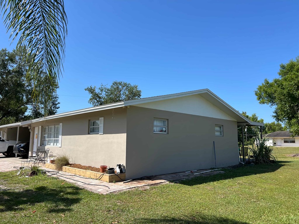 A house with a beige exterior and a white roof.