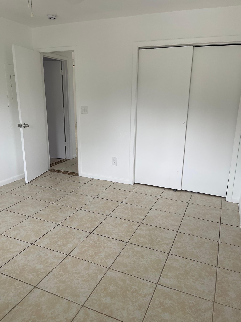 A room with white walls and a tiled floor.