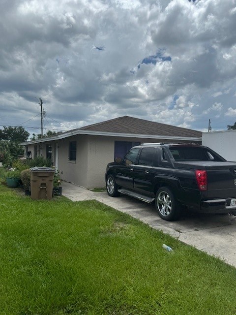 A black truck is parked in front of a house.