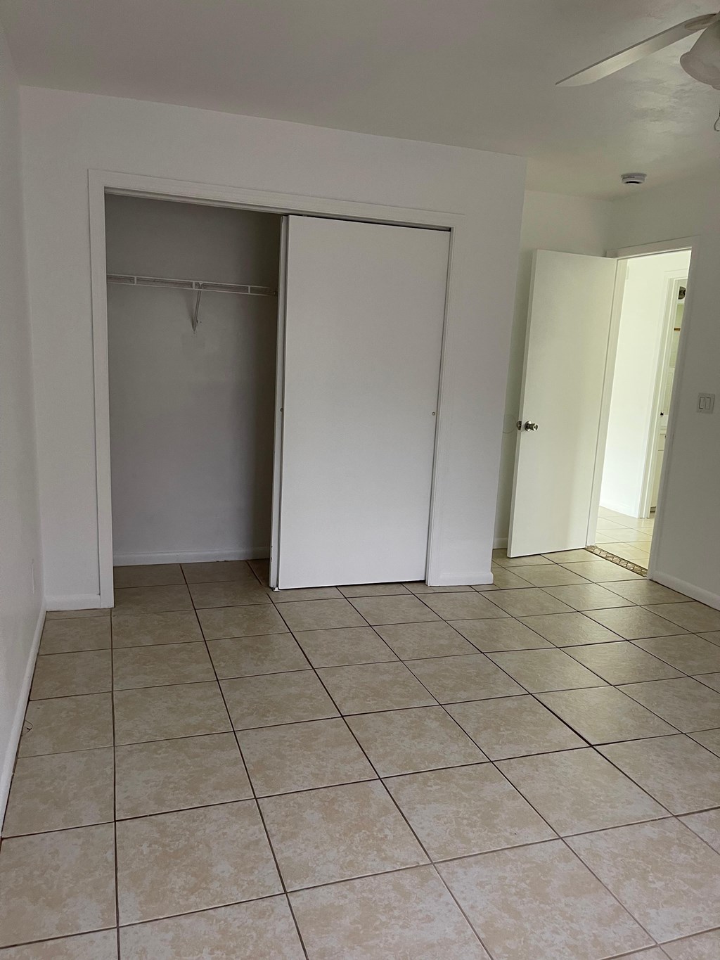 A room with a white door and a white closet.