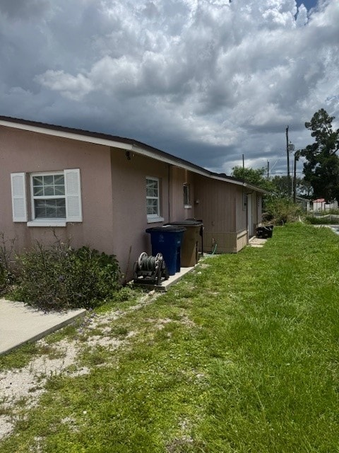 A house with a brown roof and a blue trash can.