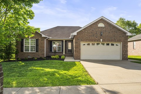A house with a brick exterior and a white garage door.