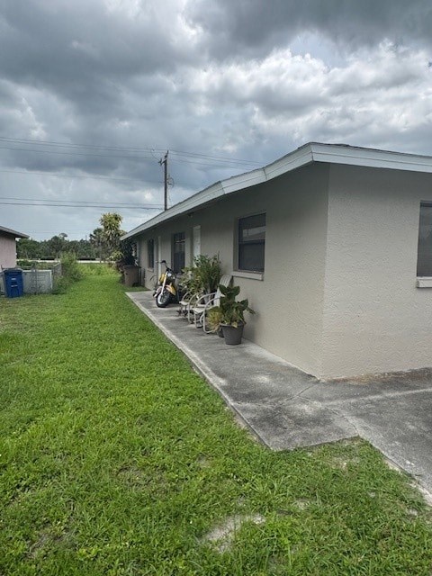 A house with a grey roof and a green lawn.