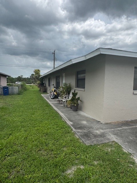A house with a grey roof and a green lawn.