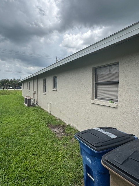 A row of houses with a blue trash can in front of the first house.