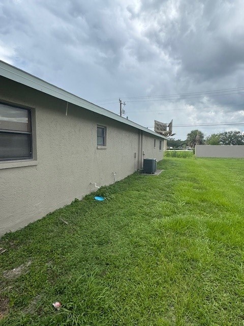 A house with a green lawn and a blue object on the grass.