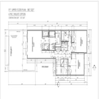 A black and white architectural floor plan shows a kitchen, living room, and bedrooms.