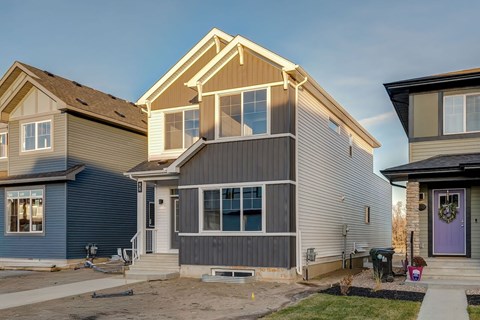 A row of houses with different colors and designs.
