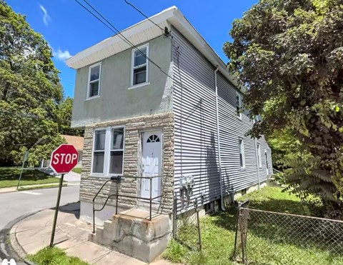 A house with a stop sign in front of it.