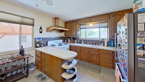 A kitchen with wooden cabinets and a white countertop.