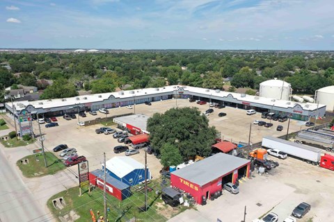 A large industrial area with a variety of buildings and vehicles.