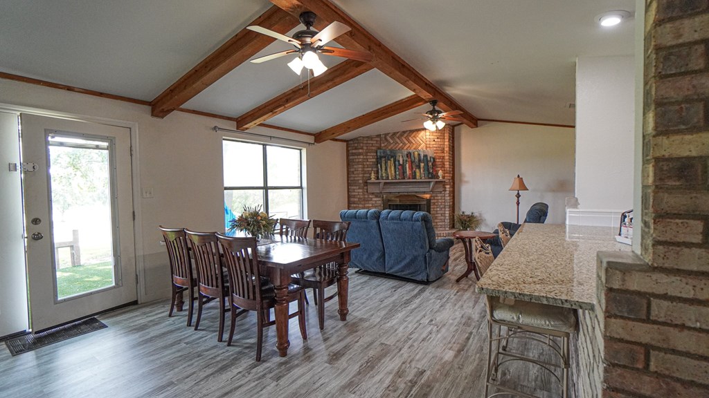 A dining room with a wooden table and chairs.