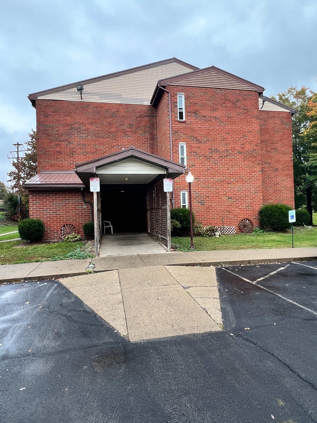 A red brick building with a white sign on the right side.