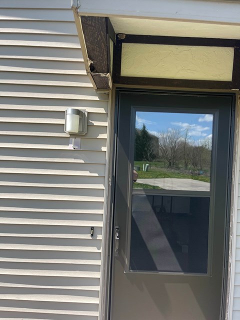 A door with a window above it on a house.