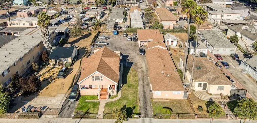 A residential area with houses and cars.