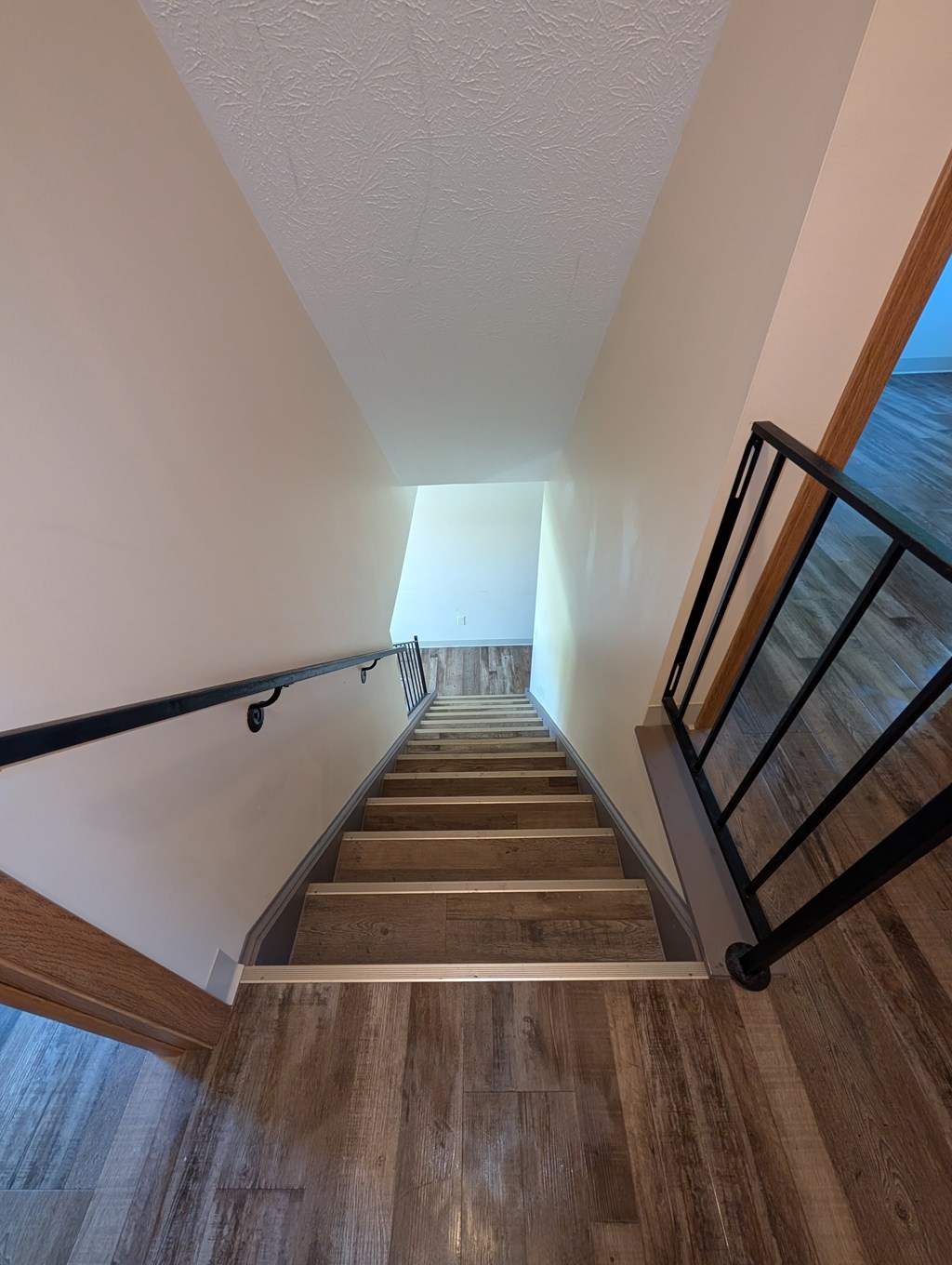 A staircase with wooden steps and metal handrails.