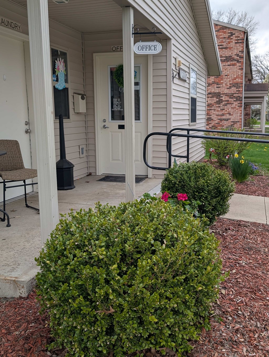 A white door with a glass window and a sign above it that says "OFFICE".